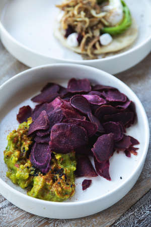 Very tasty beetroot veggie chips and guacamoleの写真素材