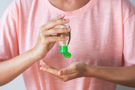 Woman with a small bottle of hand sanitizerの写真素材