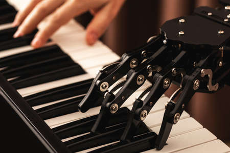 Human with neural hand prosthesis playing pianoの写真素材