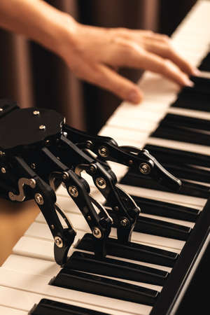 Human with neural hand prosthesis playing pianoの写真素材