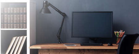 Home workplace desk with computer in the interiorの写真素材