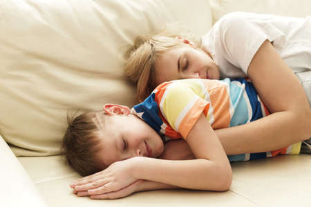 Mother and son sleeping on the sofaの写真素材