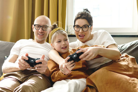 Happy family is playing video game console at home