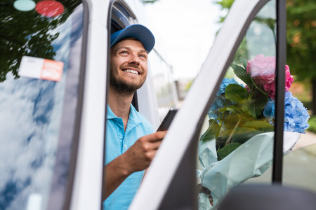 Courier inside the white van during flowers delivery is waiting for a clientの写真素材