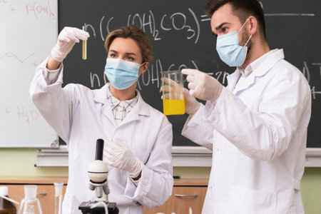 Scientist colleagues is working with a chemical reagents in a laboratory during researchの写真素材