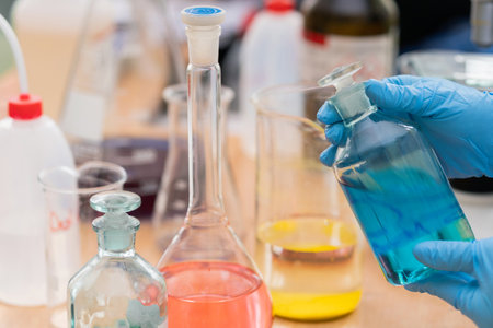 Different chemical flasks and scientist handsの写真素材