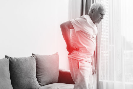 Senior man is suffering from pain in lower backの写真素材