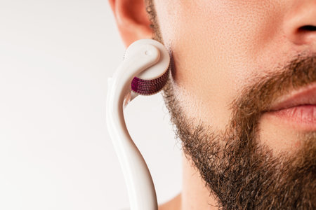 Man using meso roller for better beard growthの写真素材