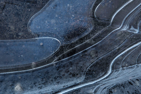 Close up of frozen puddle surface after first frostの写真素材