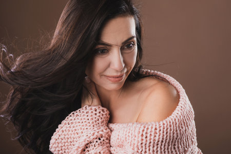 Portrait of beautiful middle aged woman wearing warm woolen sweaterの写真素材