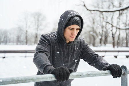 Athletic man doing push ups during his calisthenics winter workout
