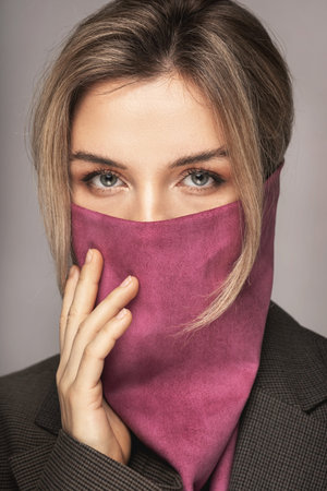 Woman wearing stylish leather bandana instead of prevention mask.
