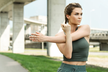 Confident woman athlete is warming up before her street workoutの写真素材