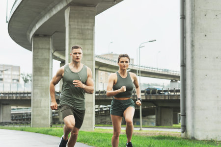 Sportive couple during jogging workout on city street