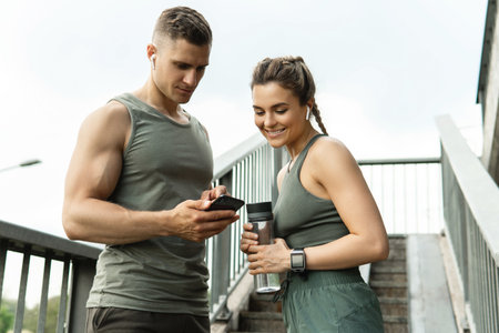 Young sportive couple relaxing after fitness workoutの写真素材