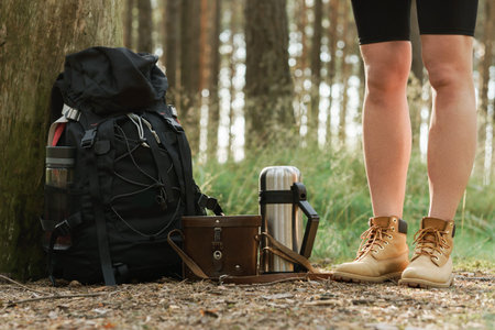 Female legs and hikers backpack on the groundの写真素材