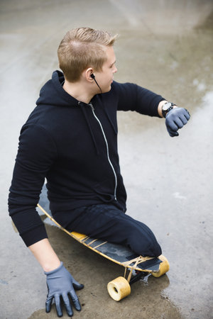Young handicapped guy with a longboard in a skatepark