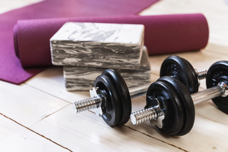 Heavy black dumbbells for bodybuilidng workout on wooden floorの写真素材