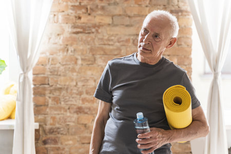 Active elderly man with is ready for his fitness workout at homeの写真素材