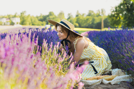 Beautiful young woman in a field full of lavender flowers