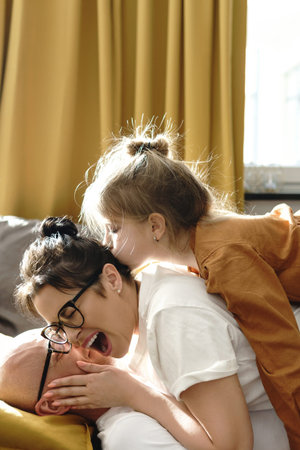 Happy family lying on the sofa and having fun at home