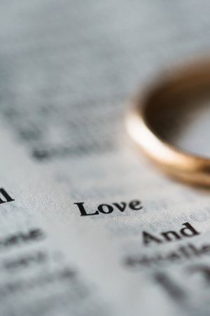 Holden wedding ring and opened pages of holy bible represents the concept of marriage and the love between two Christiansの写真素材
