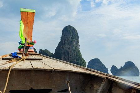 Riding on a traditional Thai long-boat on the seaの写真素材