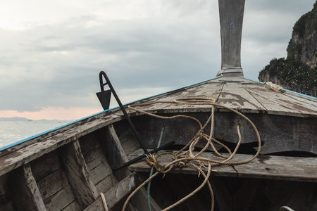 Riding on a traditional Thai long-boat on the seaの写真素材