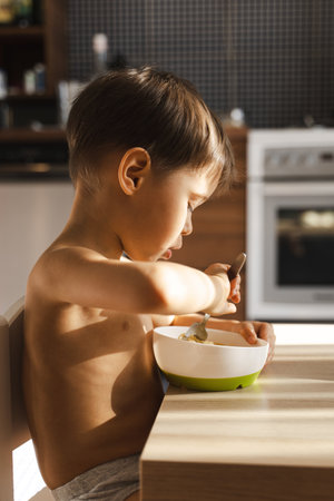 Cute toddler boy eating his favorite food - Spaghettiの写真素材