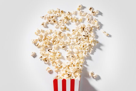 Classic striped bucket with delicious popcorn on white backgroundの写真素材