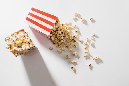 Classic striped buckets with delicious popcorn on white backgroundの写真素材
