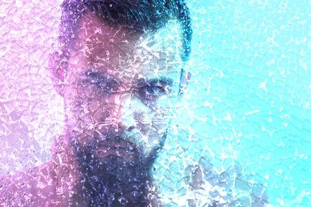 Man behind wet and cracked glass. Concepts of mental disorder or other social issues affecting human...