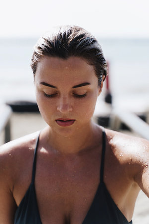 Portrait of confident and beautiful woman after swimming in the sea during sunny summer dayの写真素材