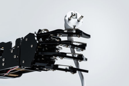 Real robotic hand with power plug. Concepts of AI takeover and Technological singularityの写真素材