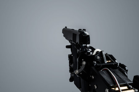 First person view of real robots hand with handgun. Concept of AI takeover and technological...