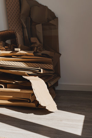 Stack of Cardboard Waste at home. Concepts of Paper Recycling and Waste Sortingの写真素材