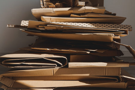 Stack of Cardboard Waste in sunlight. Concepts of Paper Recycling and Waste Sortingの写真素材