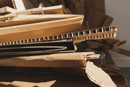 Stack of Cardboard Waste in sunlight. Concepts of Paper Recycling and Waste Sortingの写真素材