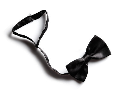 Elegant black silk bow tie on white backgroundの写真素材