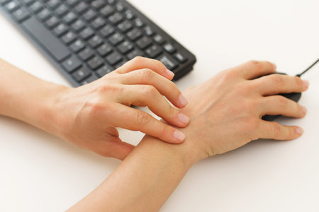 Female hands with a pain in the wrist because of carpal tunnel syndrome