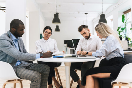 Multi-ethnic business people during meeting in modern office