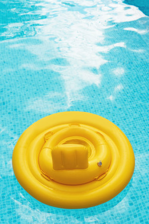 Inflatable baby float ring in open-air swimming pool