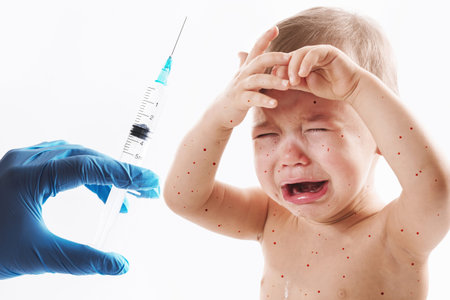 Closeup shot of an adorable upset little boy crying on white background.