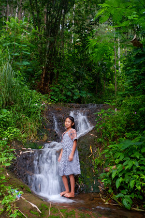 Photo of an Asian girl at a waterfallのeditorial素材