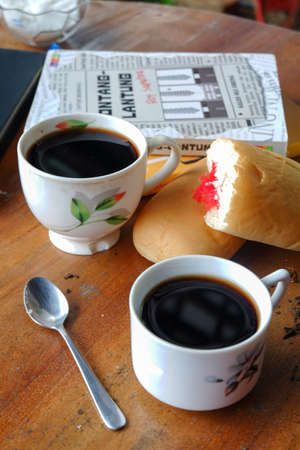 Close-up photo of someone drinking tea in the front yard of his houseのeditorial素材