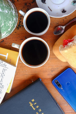 Close-up photo of someone drinking tea in the front yard of his houseの写真素材