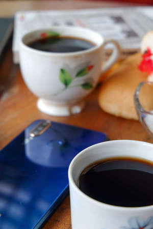 Close-up photo of someone drinking tea in the front yard of his houseのeditorial素材