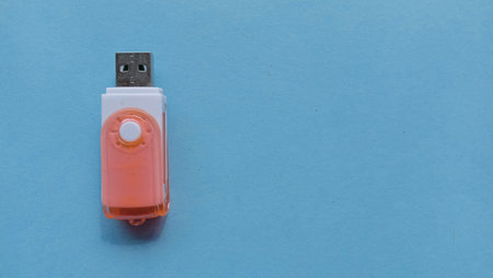 Photo of flash disk and lid on blue background, photo of electronic device