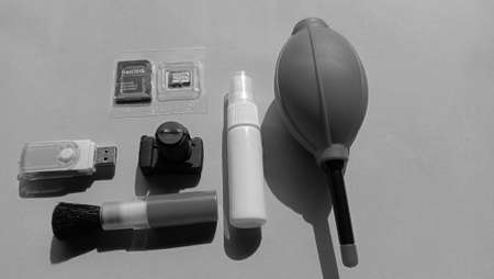 Photo of camera cleaning supplies such as blower, brush, microfiber cloth, water spray on a blue backgroundのeditorial素材