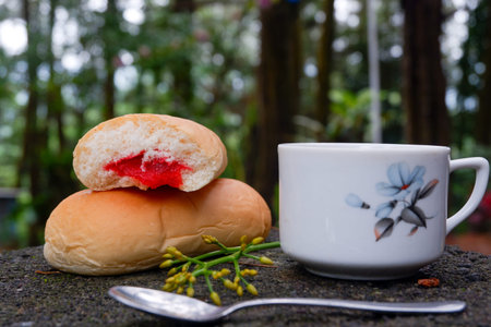 Photo of bread with strawberry jam with a cup of tea. in a photo in a forest